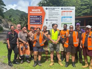 Group of waste management staff and trainers at Rarotonga standing in front of the Waste Management sign.